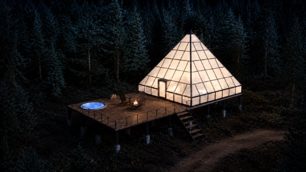 Glass pyramid suite on a raised deck at golden sunset, fire pit and hot tub above a pine forest
